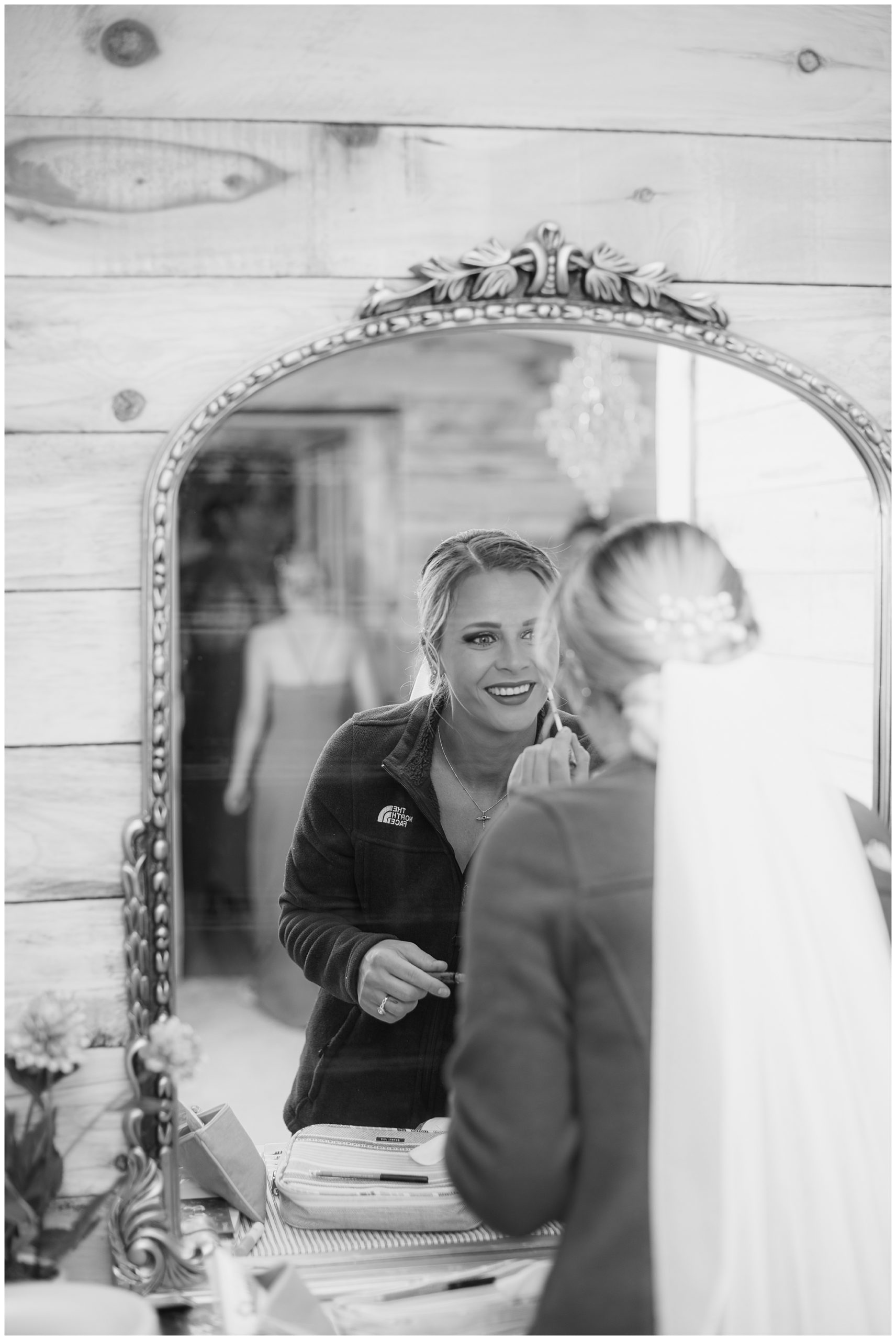 bride getting ready in mirror 