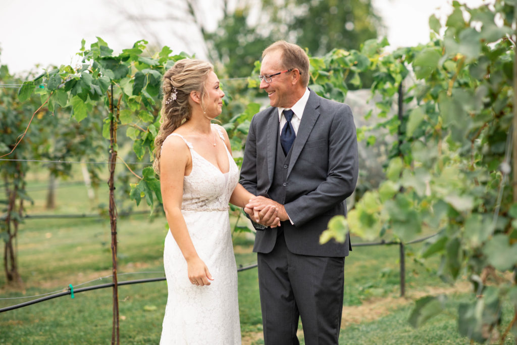 first look with dad at fall wedding on Lake Winnebago Vineyard