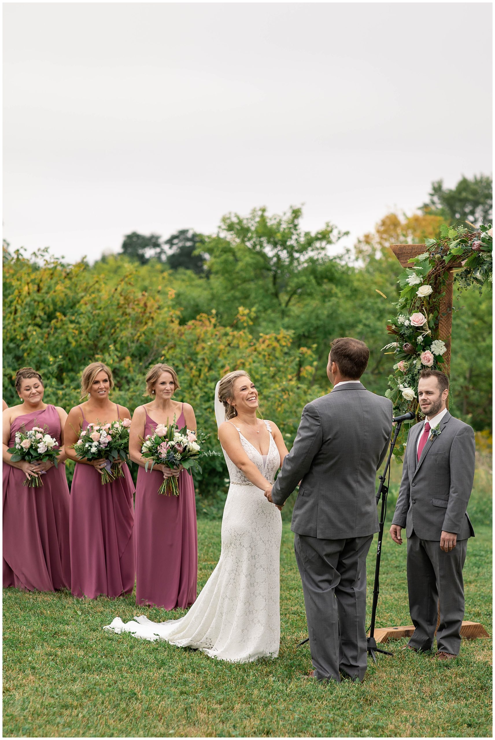 bride laughing at groom during vows