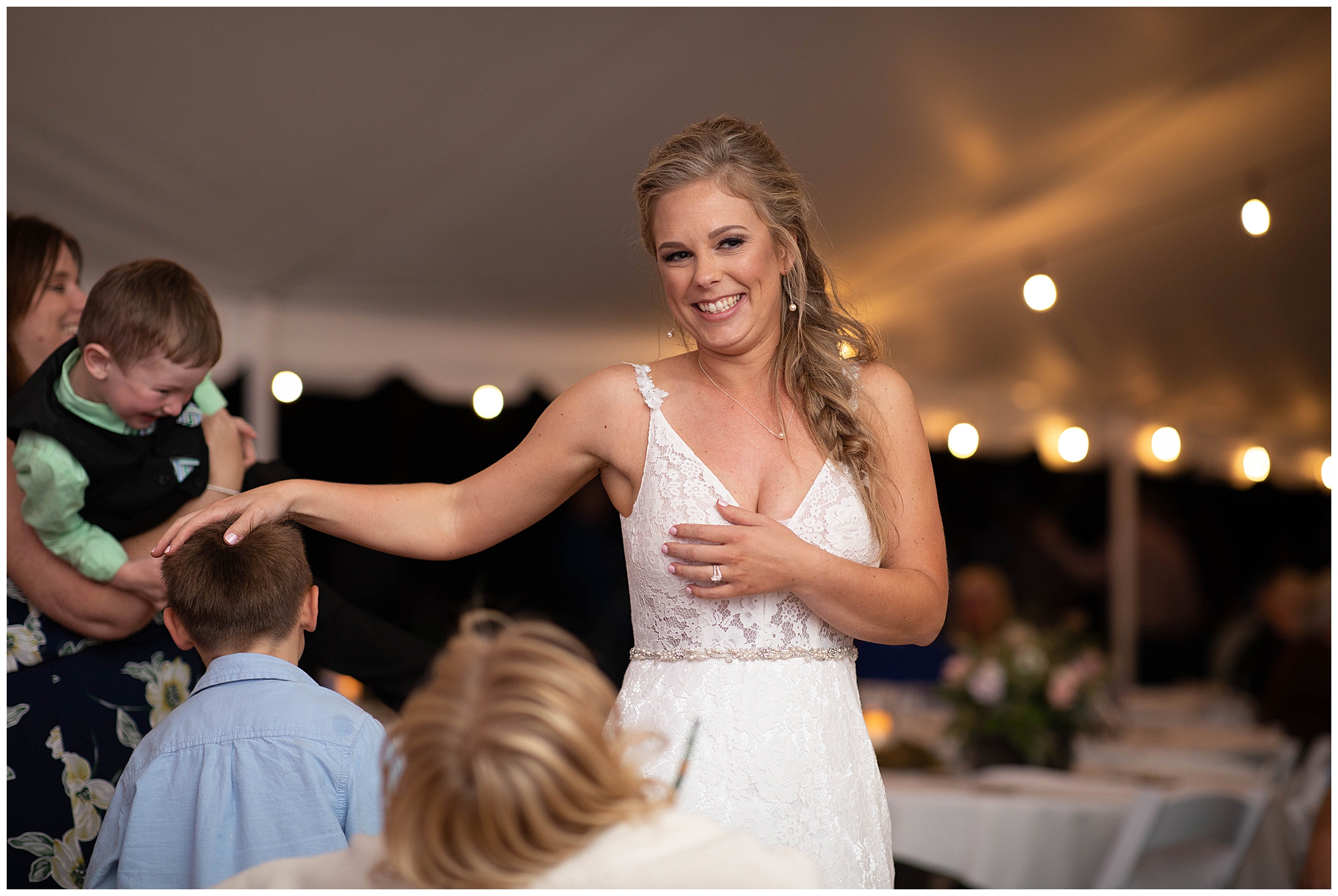 bride candid at reception under tent