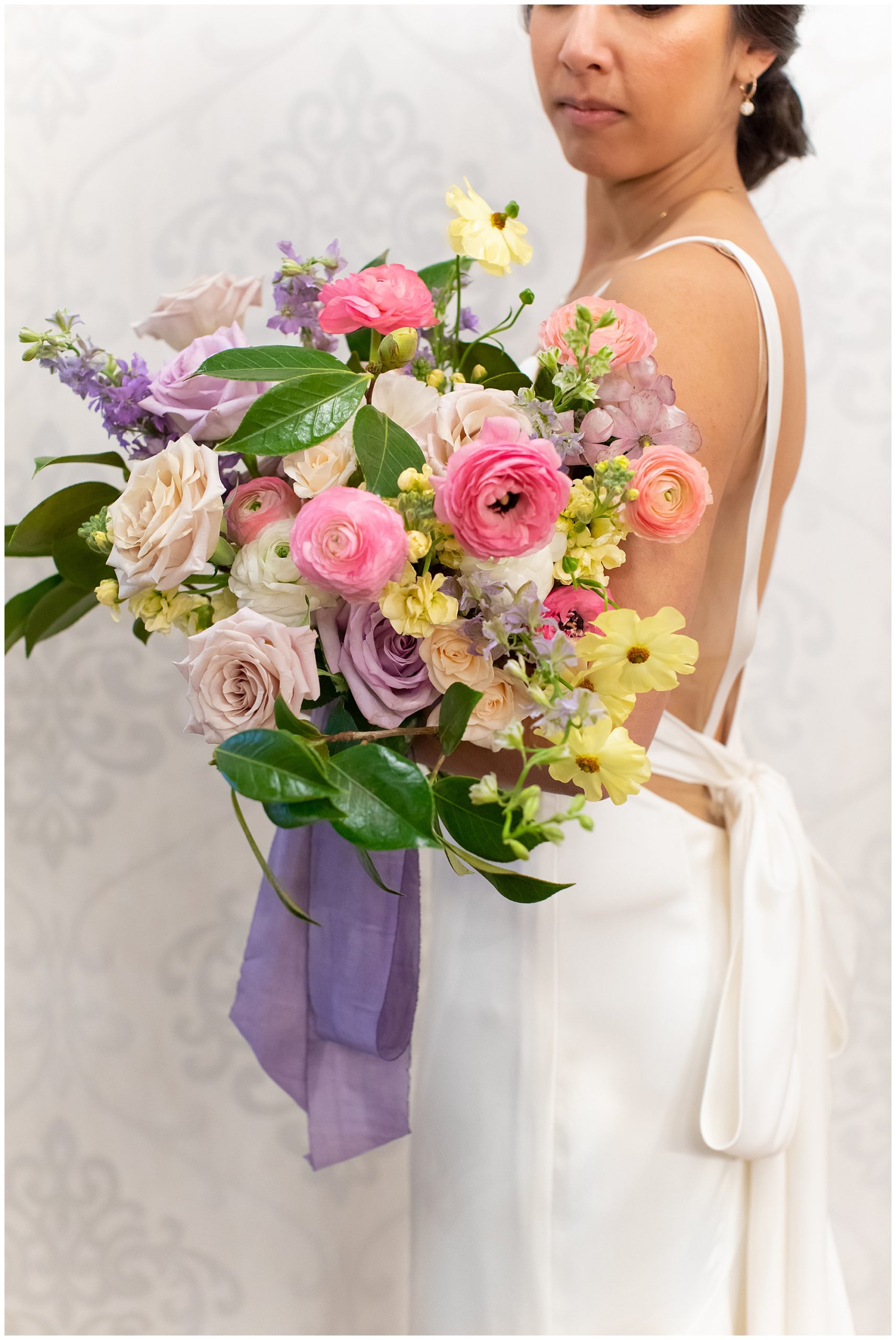 spring wedding bouquet with purple ribbon