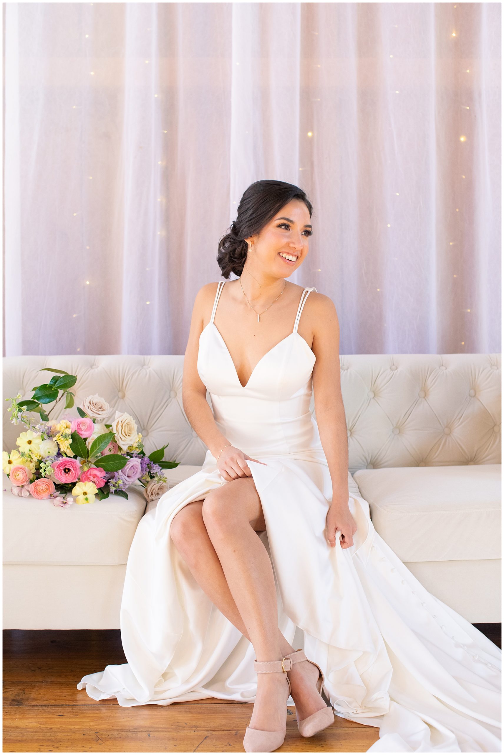 bride sitting on love seat indoors, classic updo