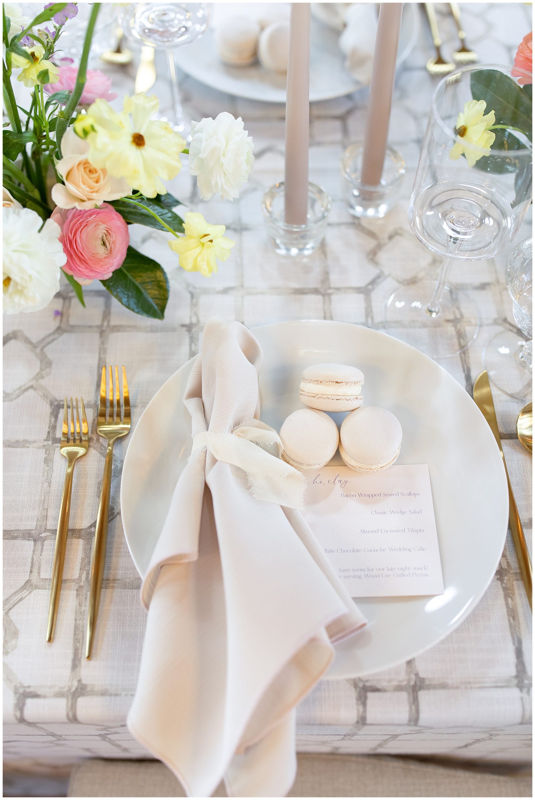 macaroons and spring florals at elegant wedding place setting